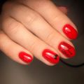 Маникюр с выравниванием ногтевой пластины, покрытием гель-лак в красном цвете со слайдер-дизайном.